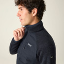 Close-up of a model adjusting the collar of the Regatta men's Cyrus Hybrid jacket in Navy/Dusky Blue.