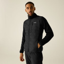Model wearing the Regatta men's Cyrus Hybrid Jacket in Black with one hand in a pocket.