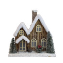 Rustic wooden Christmas house decoration with snow-covered roof, bottle brush trees and frosted winter details, perfect for festive home displays.