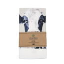 Friesian cow cotton tea towel folded with branded kraft paper sleeve packaging.