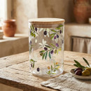 Medium clear storage canister with a natural bamboo lid and colourful olive branch print, displayed on a rustic wooden table with olives and olive leaves.