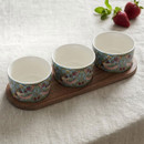 Set of three William Morris Strawberry Thief fine china snack bowls on an acacia wood serving tray, featuring the iconic bird, strawberry and floral design on a soft blue background, displayed on a linen tablecloth beside fresh strawberries.