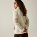 Rear view of a woman wearing a Regatta women's cream borg fleece jacket, showing the back and high collar.
