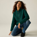 Woman kneeling while wearing the Regatta women's deep pine longline borg fleece.