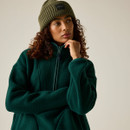 Close-up of a woman wearing the Regatta women's deep pine longline borg fleece with a knitted beanie.