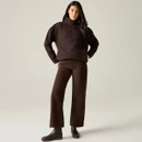 Full-length view of a woman wearing the Regatta women's chocolate longline borg fleece with brown trousers and black ankle boots.