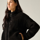 Close-up of a model wearing the Regatta women's black borg fleece jacket with a high collar and zipped chest pocket.