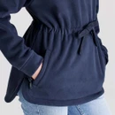 Close-up of the fleece smock's adjustable drawcord waist and zipped hand pocket.