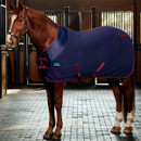 Chestnut horse wearing a navy fleece horse rug with burgundy trim, standing in a stable to showcase the full left-side fit and coverage.