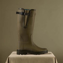 Side profile of a Le Chameau green Wellington boot showing the adjustable calf gusset, buckle strap and treaded sole.