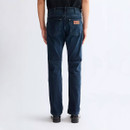 Rear view of Wrangler Greensboro slim straight-fit dark blue denim jeans on a male model, highlighting the back pockets, leather logo patch and straight-leg fit.