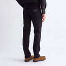 Rear view of Wrangler Greensboro slim straight-fit black denim jeans on a male model, showcasing the back pockets, tonal logo patch and straight-leg fit.