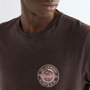 Close-up of the Wrangler chest graphic, showcasing the distressed circular "American Original" logo with authentic vintage styling against the rich Choc Torte cotton fabric.