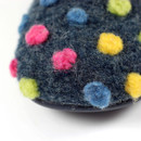 Close-up of the felt upper showing colourful raised polka dots on dark grey fabric, highlighting the soft wool texture and handcrafted finish.
