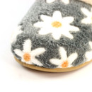 Close-up of the grey slipper toe highlighting the soft fleece fabric, white daisy pattern and plush texture.