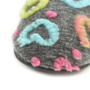 Close-up of the grey fabric upper with raised multicoloured heart print detailing, highlighting the soft textured finish of the slipper.