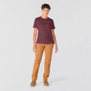 Full-length front view of women’s burgundy Carhartt graphic T-shirt styled with brown work trousers and boots.