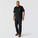 Full-length view of a man wearing a black Carhartt pocket T-shirt with black trousers and brown work boots.