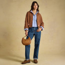 Brown collared cardigan styled over a striped shirt and jeans, featuring floral detailing along the sleeves and hem.
