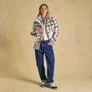 Full-length styling shot showing the fleece layered over a shirt and paired with relaxed denim.