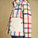 Close-up showcasing the contrast patch pocket, branded popper detail and textured check fleece.
