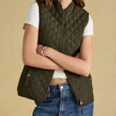 Close-up styling shot highlighting the quilted texture, curved hem and antique brass hardware.