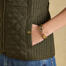 Close-up highlighting the practical side pocket, branded popper and contrasting quilted panels.