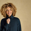 Close-up showcasing the high funnel neck, half-zip fastening and relaxed dropped-shoulder shape.