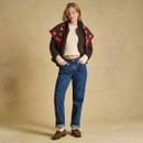Full-length styling shot showing the jumper layered under a jacket for an easy everyday look.