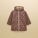 Front view showcasing the chocolate brown coverall, playful equestrian-inspired print, contrasting pink zip and cosy fleece-lined hood.