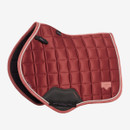 Coral red LeMieux close contact saddle pad with square quilting, contrasting rope trim, black girth protection panel and branded badge on a white background.