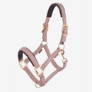 Pale pink LeMieux softshell horse headcollar with padded noseband and headpiece, adjustable straps and gold-coloured buckles and fittings.