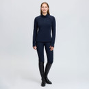 Woman modelling a navy LeMieux women’s quarter-zip fleece with riding breeches and tall black equestrian boots.