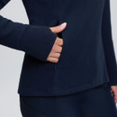 Close-up of the navy LeMieux women’s fleece showing a discreet zipped side pocket and long sleeve cuff.