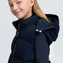 Close-up of a navy LeMieux children’s padded gilet showing the hood attachment, gold poppers and branded lining.