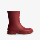 Side view of a Hunter Downpour short wellington boot in merlot red with a chunky lug sole.