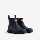 A pair of navy blue Chelsea boots with elastic sides and branded labels from Hunter Boot Company.
