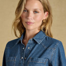 Model wearing a denim western shirt mid wash with a collar and button details.