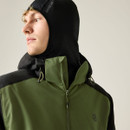 An angled view of a man wearing a black and green Dare 2b jacket with a hood and zip closure.