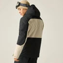 A male model wearing a black and beige jacket with a hood, seen from behind, against a plain background.