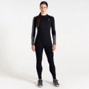 A woman is wearing a black and grey long-sleeve fitness top and black leggings with grey accents and athletic shoes.