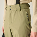 A close-up of olive green ski trousers with adjustable straps and side zip pockets.