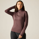 A woman wearing a fitted, long-sleeved, high-neck stretch top in a dark berry colour.