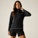 A woman models a black long-sleeve zip-up top and matching shorts from Dare 2b.