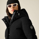 Close-up of black Dare 2B padded cord jacket showing high collar, hood and sleeve logo badge.