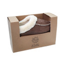 Brown mule slippers with a cream fur lining, presented in a brown cardboard box.