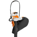 STIHL cordless leaf vacuum with black collection bag, long suction tube and shoulder strap on a white background.