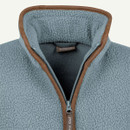 Half-zip sherpa fleece in light blue with a brown trim around the collar and zipper, displaying a cosy texture.