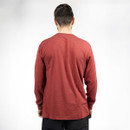 Male model wearing a red CAT long sleeve T-shirt, shown from the back with a plain rear design.