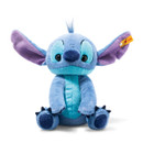 Steiff Disney Originals Stitch plush toy with blue fur, large purple-lined ears, turquoise markings and dark blue claws, sitting against a white background.